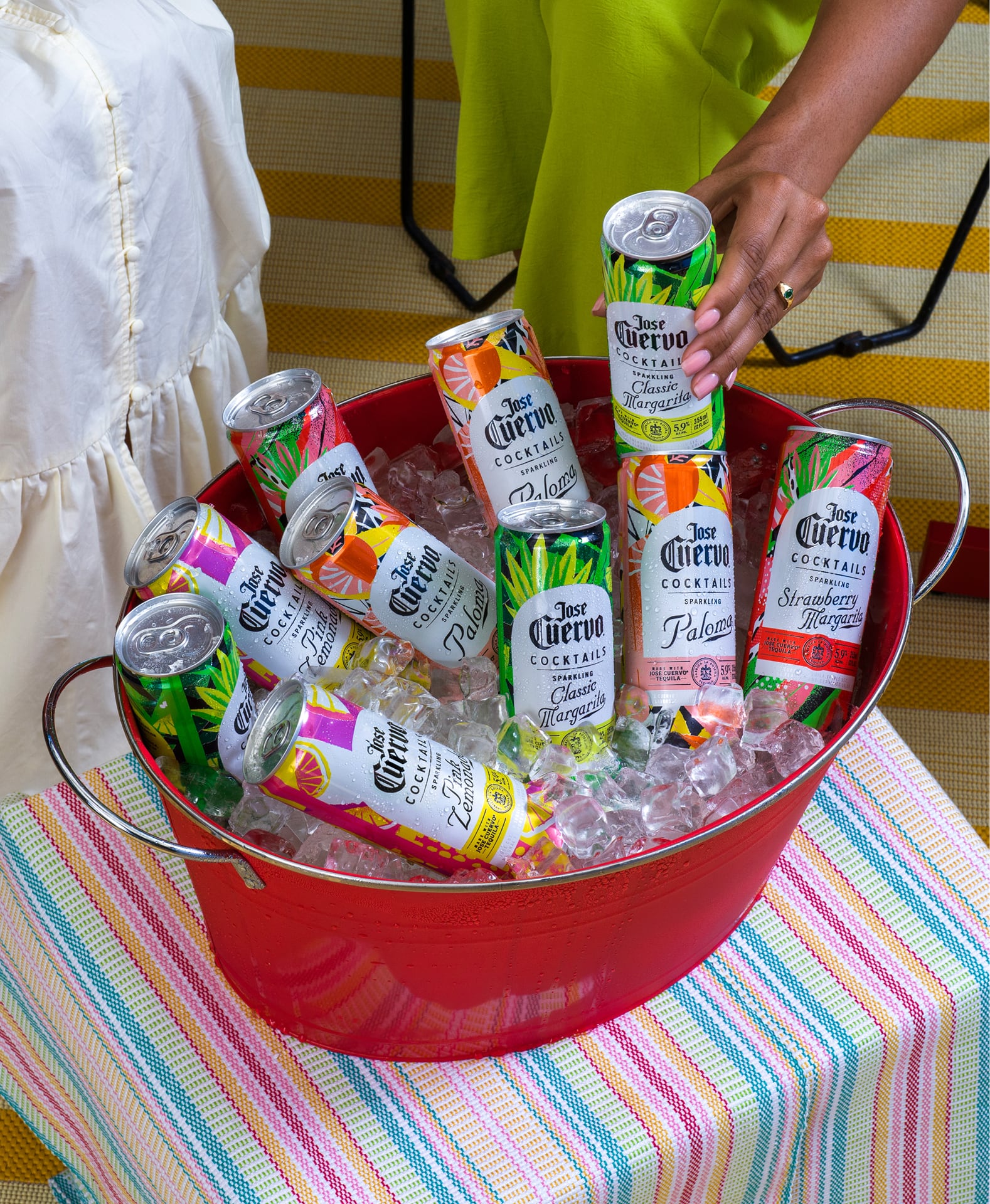 Jose Cuervo Sparkling Cocktails Variety Pack cans chilling in an ice bucket with Strawberry Margarita, Classic Margarita, Paloma, and Pink Lemonade flavors