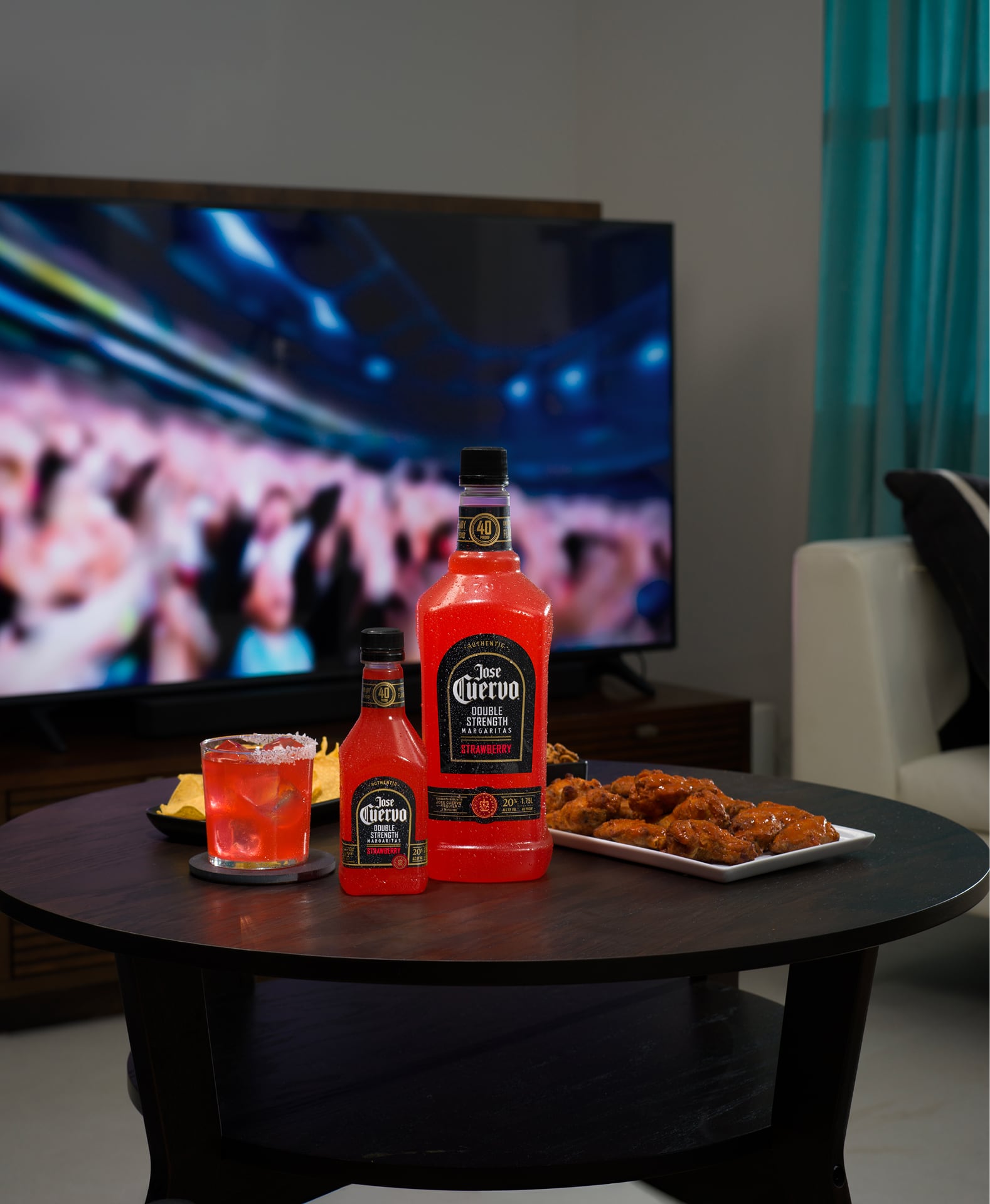 Jose Cuervo Double Strength Strawberry Margarita ready-to-drink cocktail bottle with food on the side in a living room