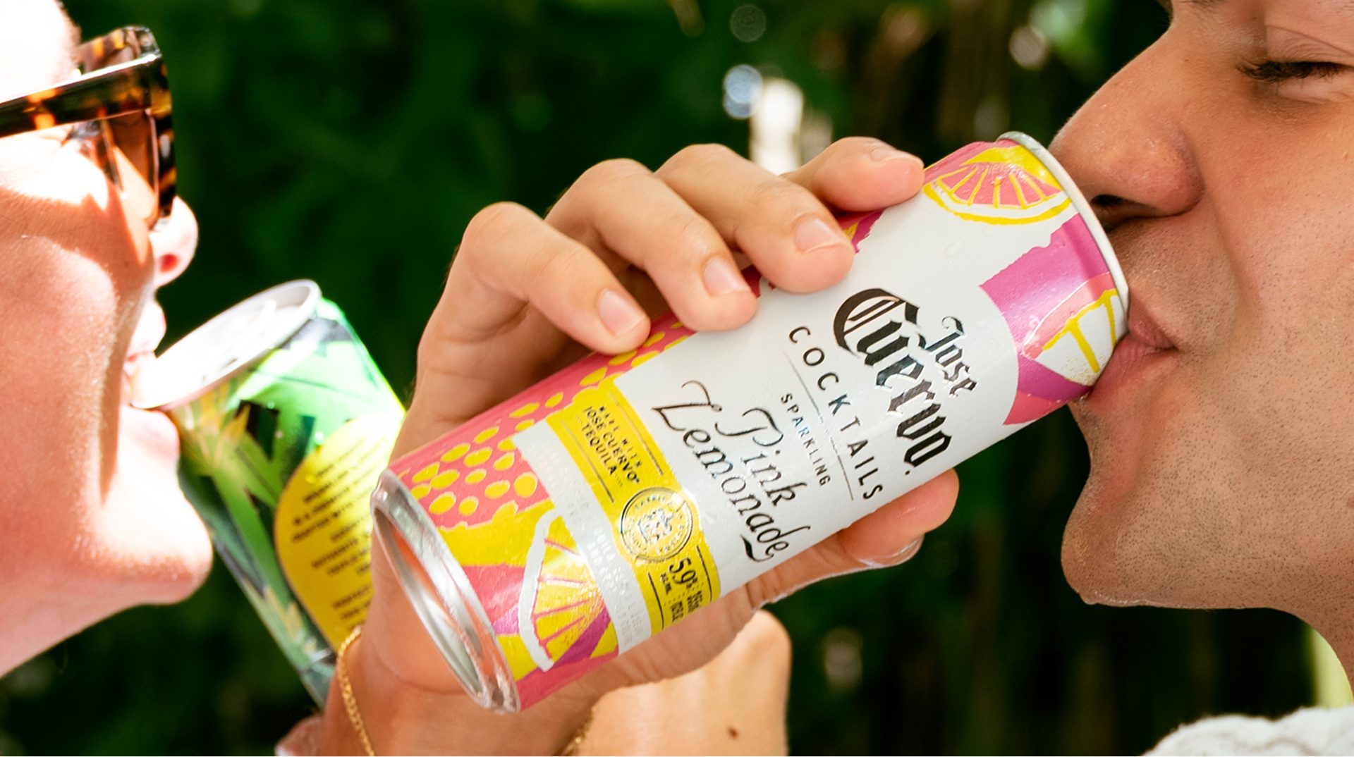 Two people drinking Jose Cuervo Sparkling Pink Lemonade canned cocktails outdoors